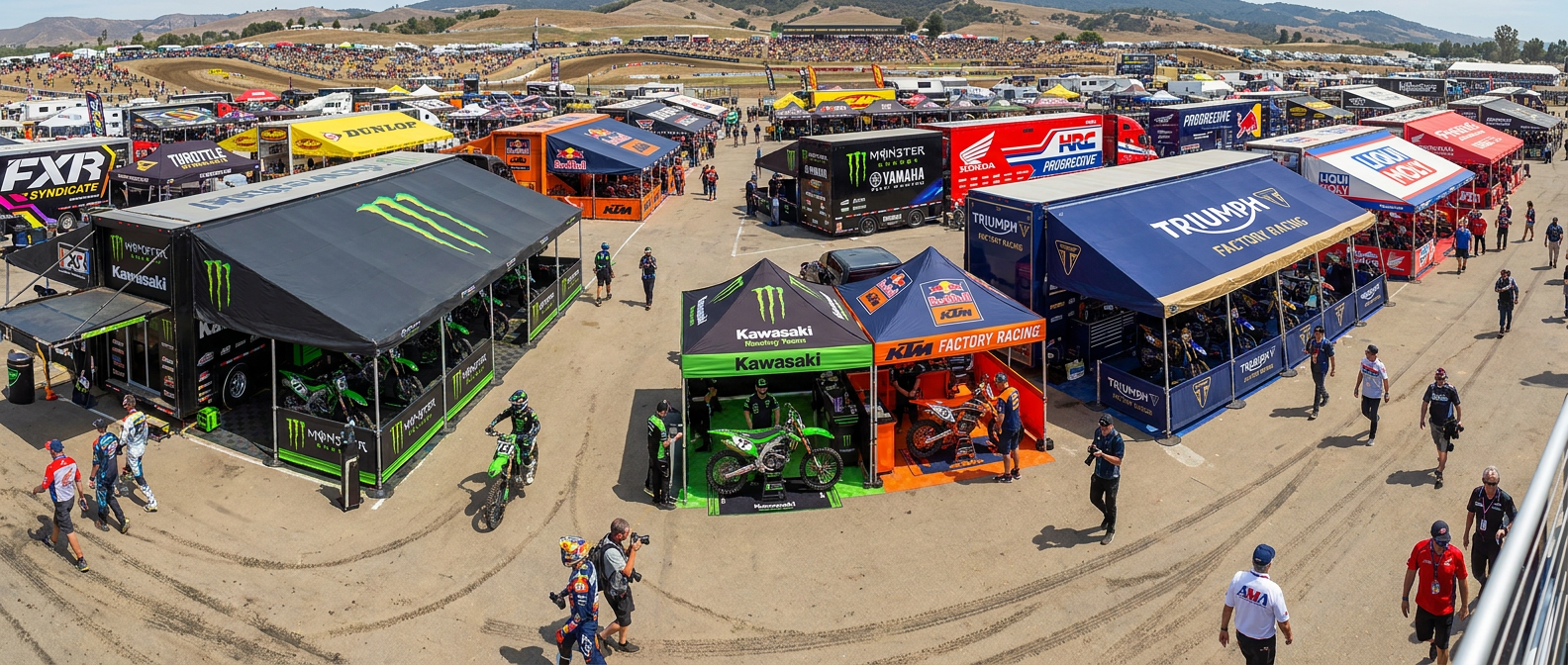 Dirt bike and ATV pit tent setup at a motocross paddock